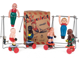 Wind-up acrobats hanged from metallic horizontal bars, from the 1950s. The one on the left, made by the Japanese company Toyland toy, the other by the Greek toymaker Ananias Ananiadis