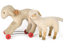 Plush toy lambs, with the biggest one, made by Lambropoulos Bros. in the 1950’s, rolling on wooden wheels, attached to a wire frame. The other is of unknown provenance, probably from the Interwar period