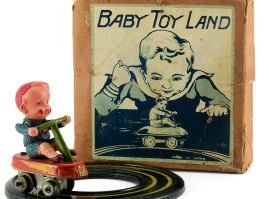 Small celluloid boy on a four-wheel tin wind-up bicycle moving on a circular track. Made by the Japanese company “Tagai” in the 1950s. The packaging box states the identity of the toy and the country of origin