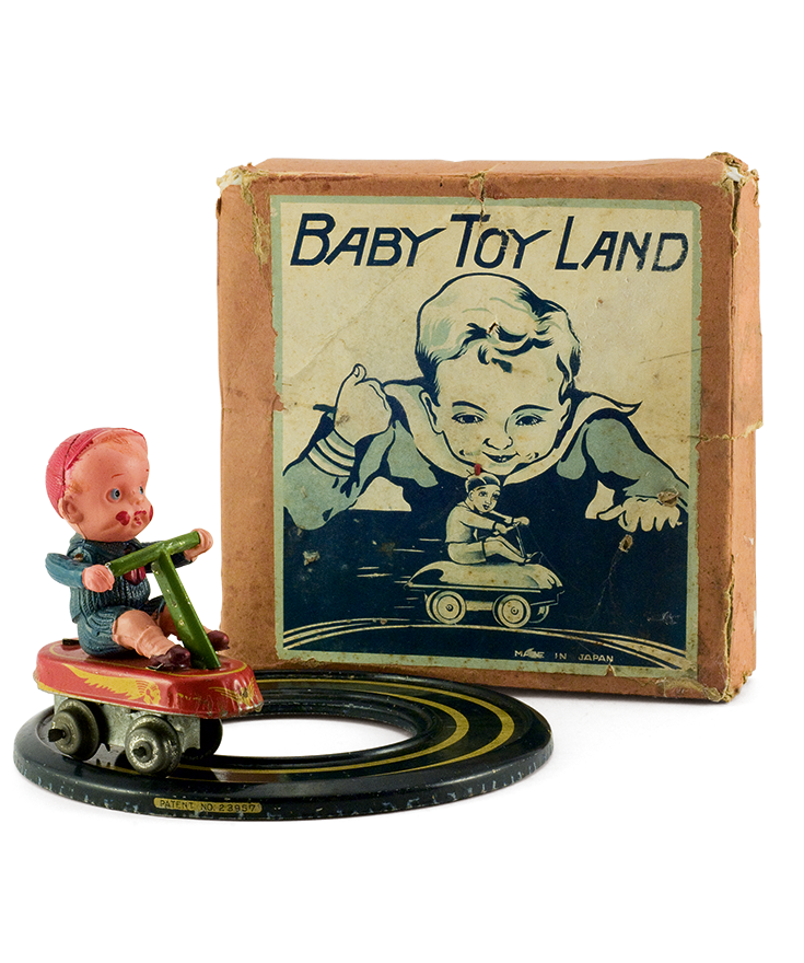 Small celluloid boy on a four-wheel tin wind-up bicycle moving on a circular track. Made by the Japanese company “Tagai” in the 1950s. The packaging box states the identity of the toy and the country of origin