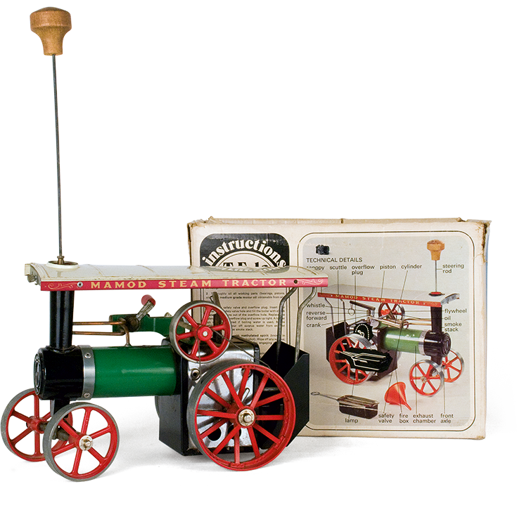 Metal steam-operated tractor made by the English company “Mamod”. Its front wheels turn by rotating the steering rod screwed onto the steam engine’s smokestack. The packaging box depicts technical details and instructions for safe operation and use