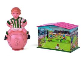 «Soccer» piggy banks: The one, made of bone, with the form of a boy sitting on a ball, of Greek origin, from the 1950s. The other, tin lithograph, with soccer game scenes, of German origin, from the first years after the World War II