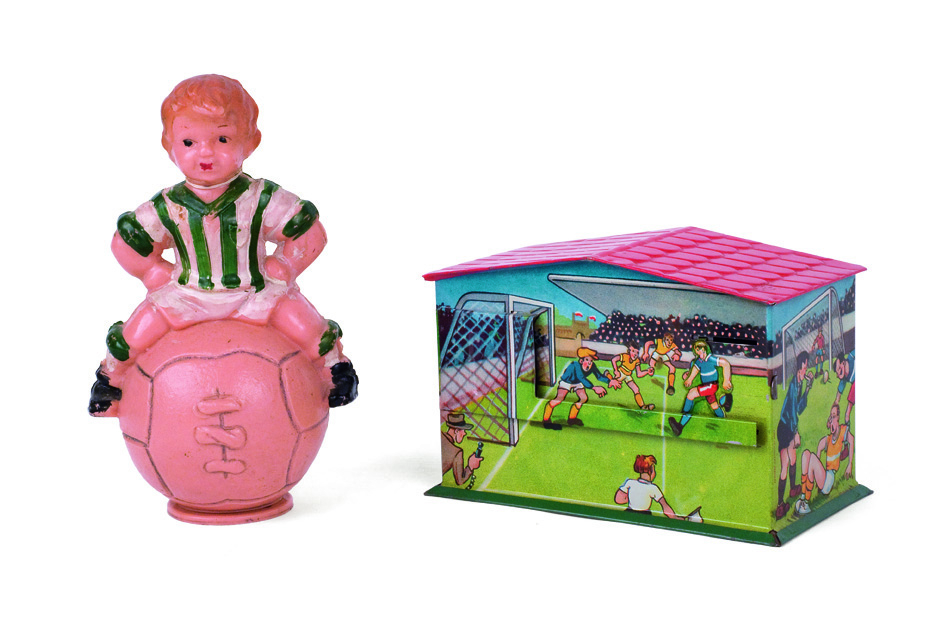 «Soccer» piggy banks: The one, made of bone, with the form of a boy sitting on a ball, of Greek origin, from the 1950s. The other, tin lithograph, with soccer game scenes, of German origin, from the first years after the World War II