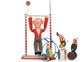 Four clowns, three of them tin and one wooden,  performing balancing acts(single bar, rolling wheel, handstand), of various companies and origin, from the 1950s