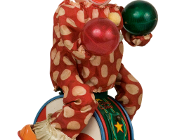 Tin lithograph clown-acrobat in a rolling drum, with plastic head and fabric clothing. Battery-operated, of Japan origin,from the 1950s