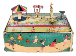 Tin wind-up toy, a miniature amusement park and playground: featuring plastic figures and a rich, lithographed rectangular tin base, of French origin from the 1950s