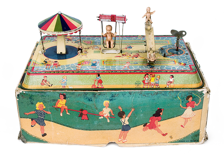 Tin wind-up toy, a miniature amusement park and playground: featuring plastic figures and a rich, lithographed rectangular tin base, of French origin from the 1950s