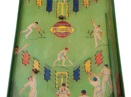 “Pin Cricket”: one-player board game with balls, a score table and a launching lever