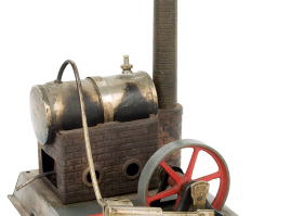 Metal steam engine adapted on a rectangular tin base, made by the German company “Wilesco”. This dates back to the 1950s-1960s