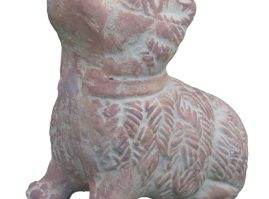 Clay model of a seated dog, with its front legs extended, concave interior, used as a rattle