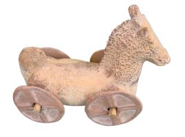 Clay horse with four wheels attached and its tail folded back