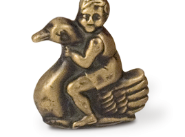 Bronze rattle in the shape of a small boy riding a swan, of unknown origin, from the interwar period
