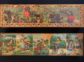 Two rectangular wooden cases with cover, the upper surface of which is decorated with printed drawings of childhood figures