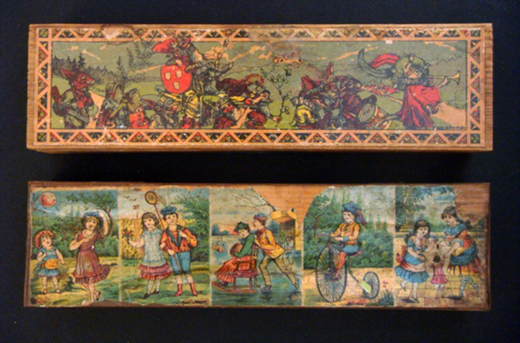 Two rectangular wooden cases with cover, the upper surface of which is decorated with printed drawings of childhood figures